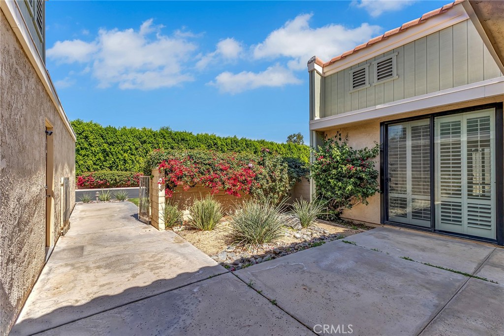72355 Roxbury Drive Rancho Mirage, CA 92270 - Photo 12 of 61 a front view of a house with a yard and garage