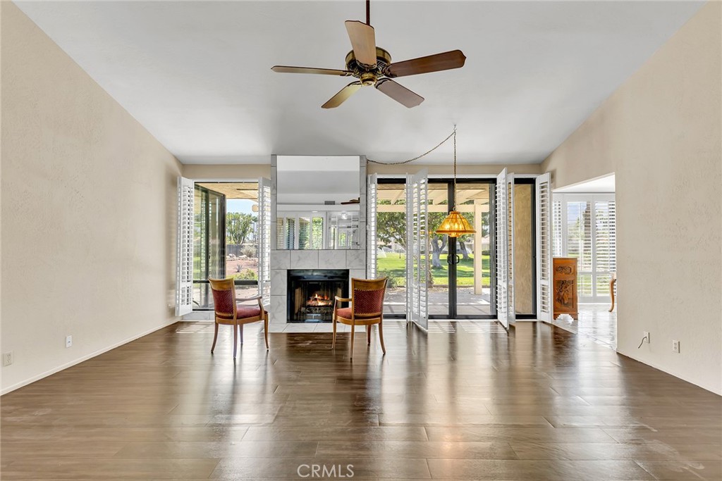 72355 Roxbury Drive Rancho Mirage, CA 92270 - Photo 16 of 61 a living room with fireplace furniture and a floor to ceiling window