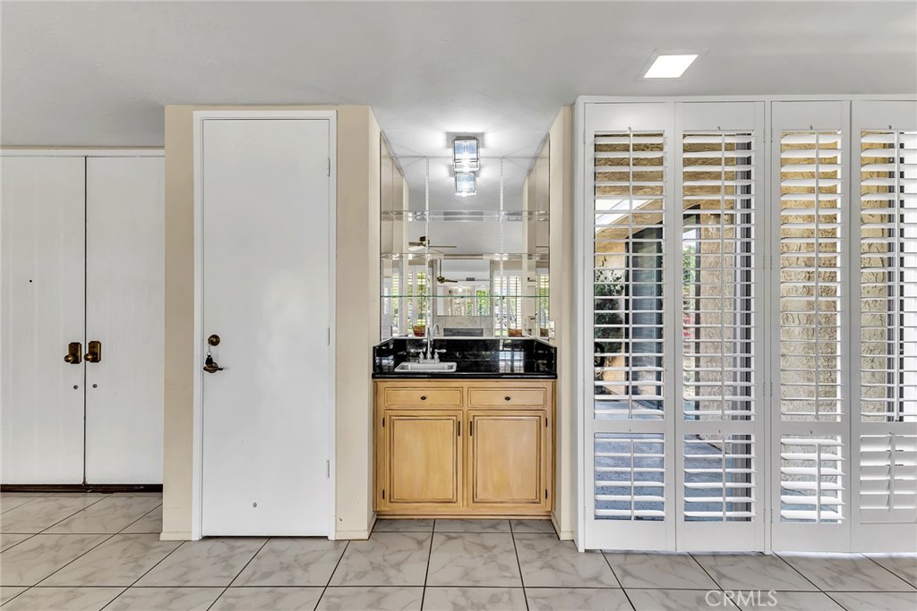 72355 Roxbury Drive Rancho Mirage, CA 92270 - Photo 20 of 61 a kitchen with granite countertop a sink a washer and dryer