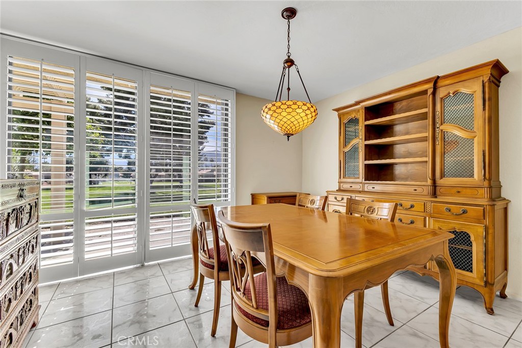 72355 Roxbury Drive Rancho Mirage, CA 92270 - Photo 22 of 61 a view of a dining room with furniture and chandelier
