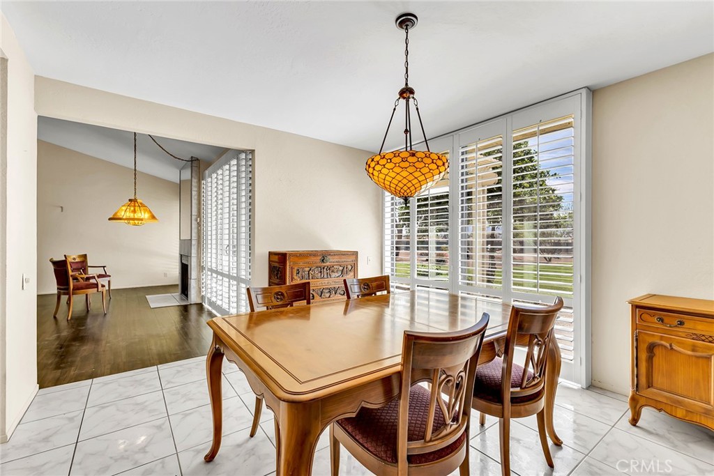 72355 Roxbury Drive Rancho Mirage, CA 92270 - Photo 23 of 61 a dining room with furniture a chandelier and window