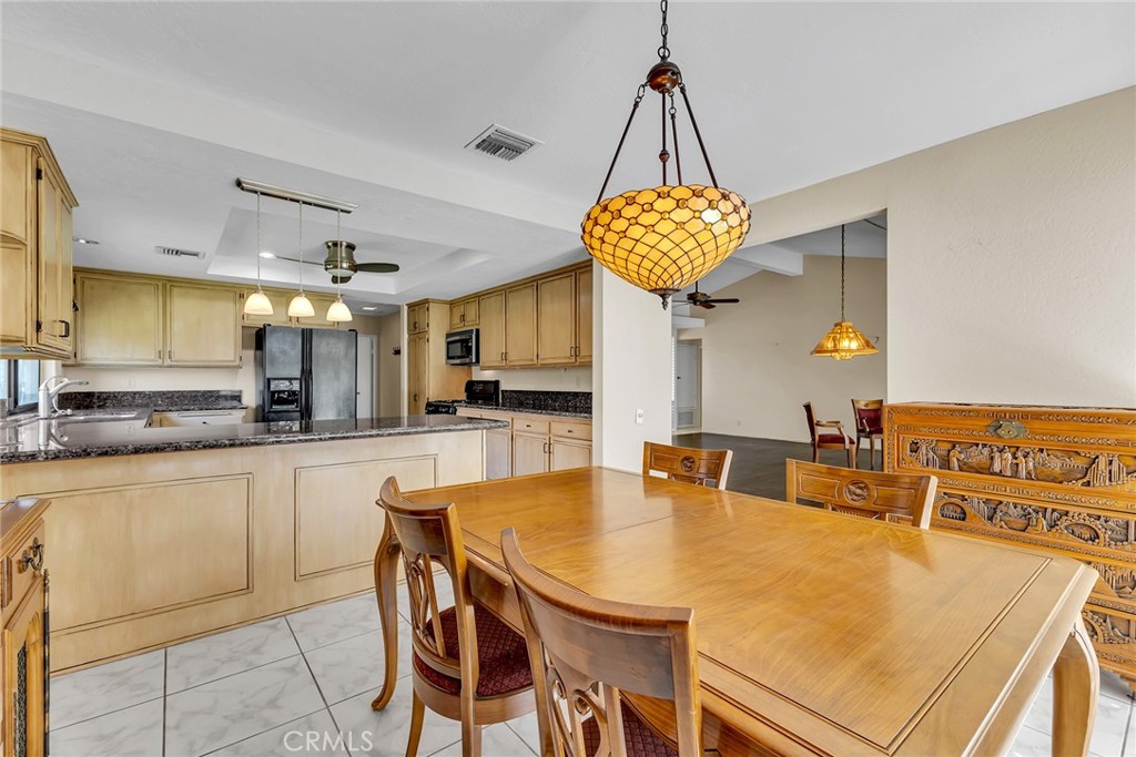 72355 Roxbury Drive Rancho Mirage, CA 92270 - Photo 24 of 61 a kitchen with a table chairs and microwave