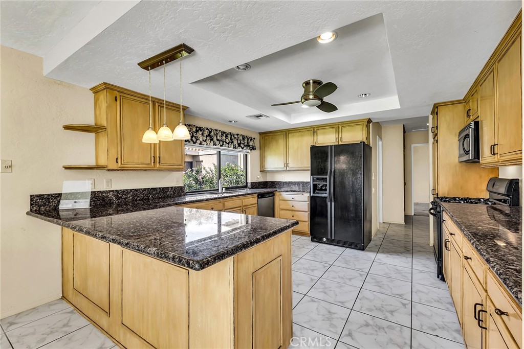 72355 Roxbury Drive Rancho Mirage, CA 92270 - Photo 26 of 61 a kitchen with granite countertop a sink appliances and cabinets