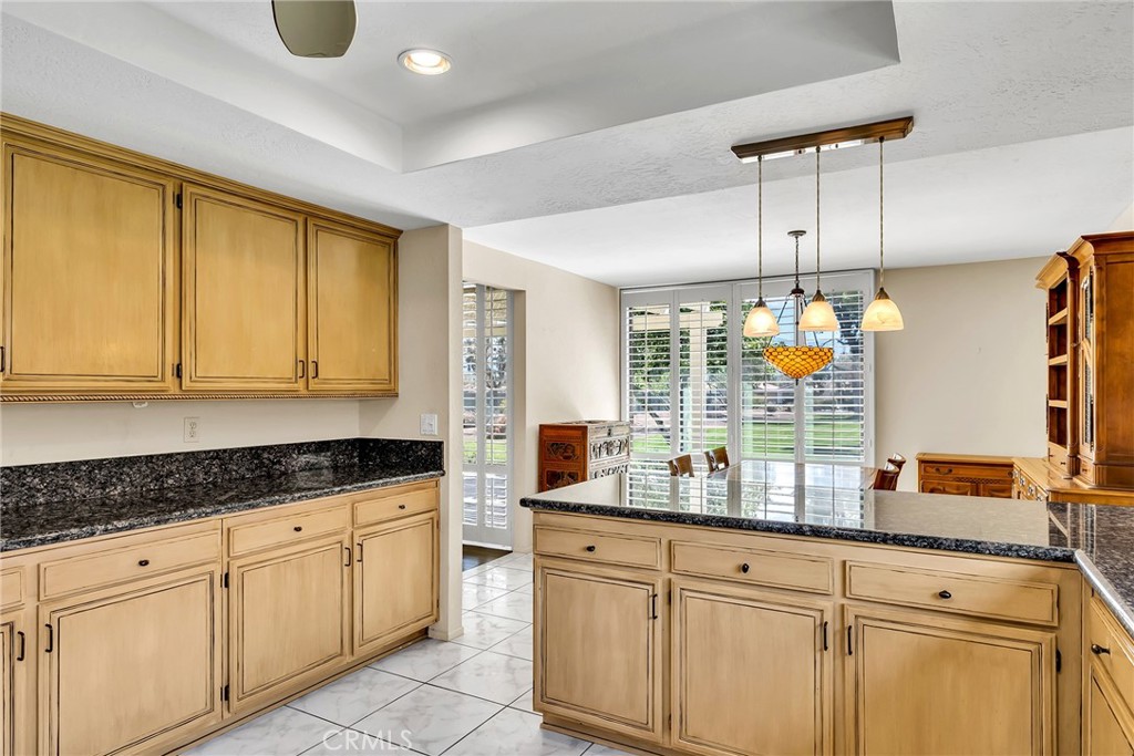 72355 Roxbury Drive Rancho Mirage, CA 92270 - Photo 29 of 61 a kitchen with granite countertop white cabinets and white stainless steel appliances