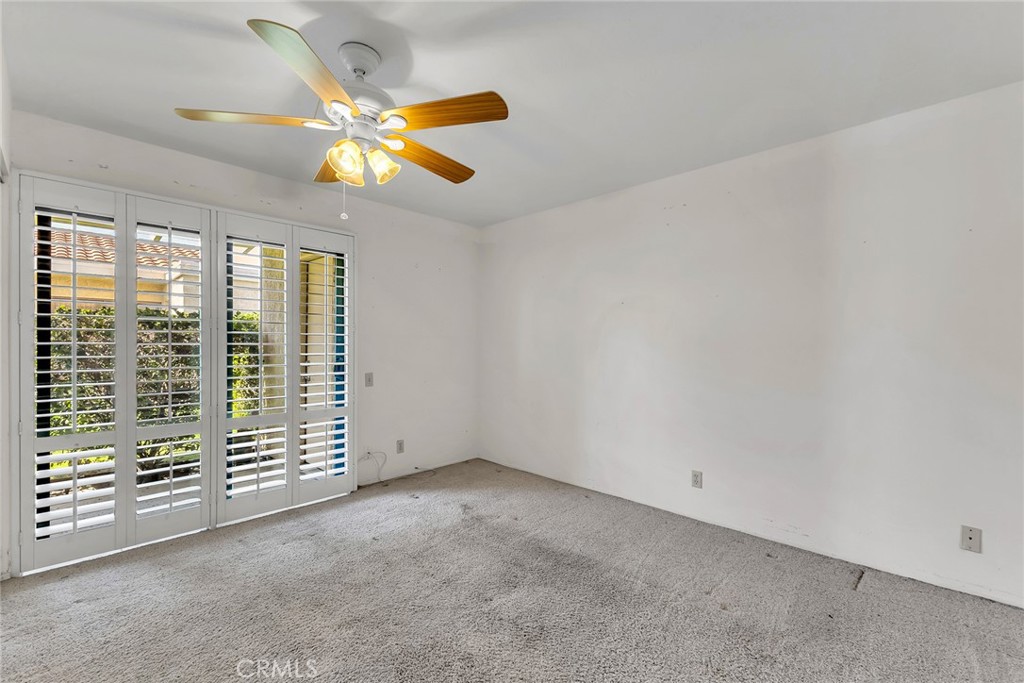72355 Roxbury Drive Rancho Mirage, CA 92270 - Photo 36 of 61 an empty room with windows and fan