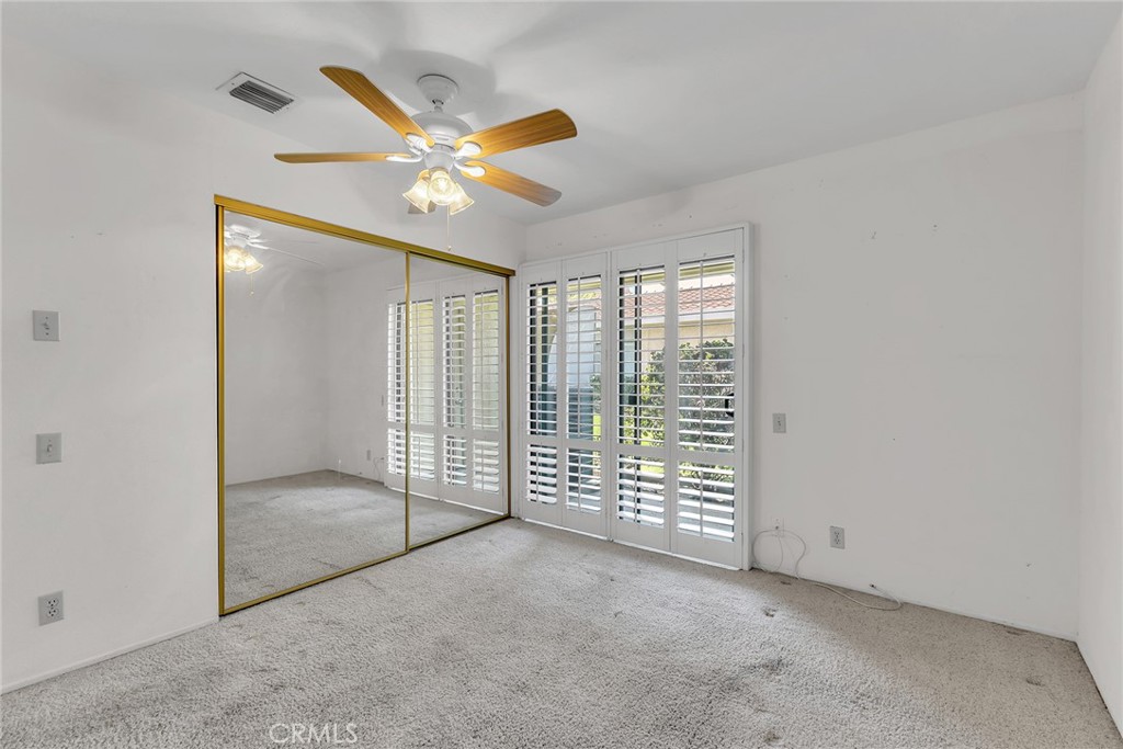 72355 Roxbury Drive Rancho Mirage, CA 92270 - Photo 37 of 61 an empty room with windows and fan