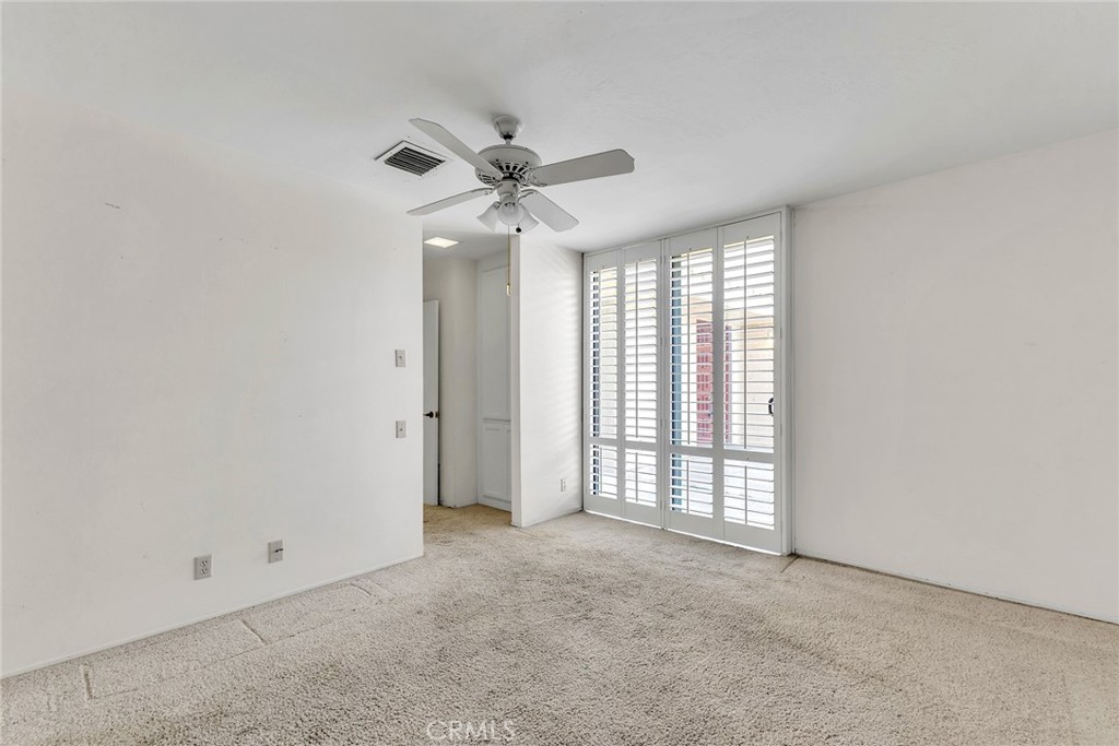 72355 Roxbury Drive Rancho Mirage, CA 92270 - Photo 45 of 61 an empty room with windows and fan
