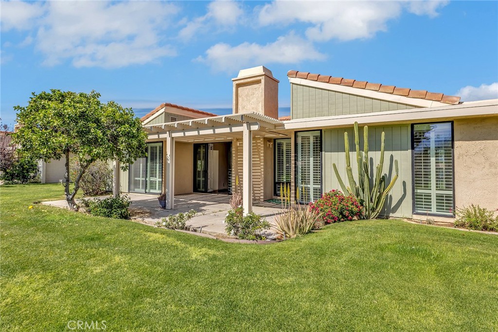 72355 Roxbury Drive Rancho Mirage, CA 92270 - Photo 52 of 61 a front view of a house with garden