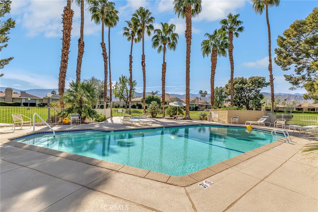 72355 Roxbury Drive Rancho Mirage, CA 92270 - Photo 53 of 61 a view of a swimming pool with a lawn chairs and palm tree