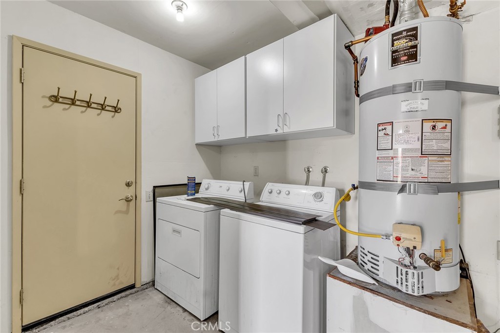 72355 Roxbury Drive Rancho Mirage, CA 92270 - Photo 58 of 61 a utility room with cabinets washer and dryer