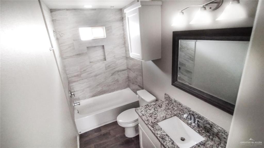 701 Cathedral Hill, Unit 1 Edinburg, TX 78541 - Photo 10 of 14 Full bathroom featuring vanity and shower combination