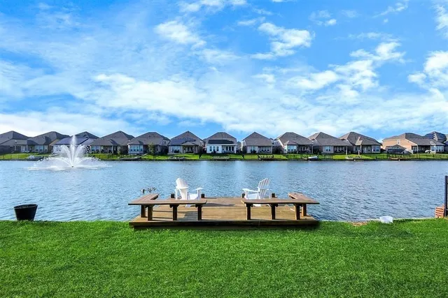 a view of a lake with houses in the background