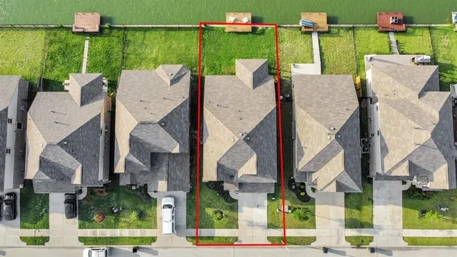 an aerial view of a house with garden space and street view