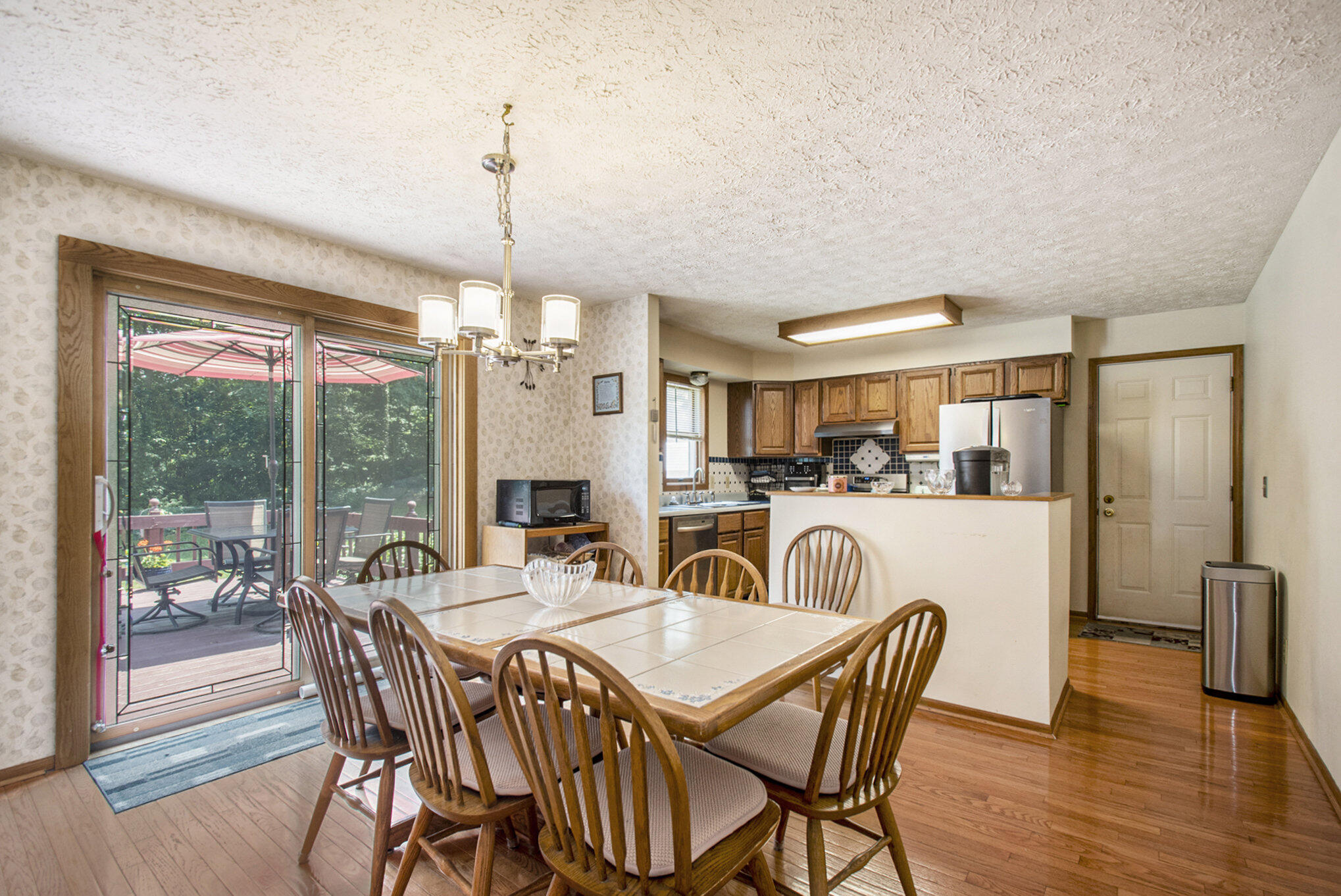 437 Johnson Road Trail Creek, IN 46360 - Photo 6 of 32 a dining room with furniture a chandelier and wooden floor