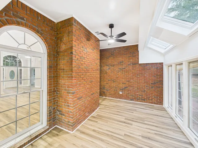 a view of a brick house with wooden floor