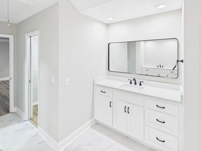 a bathroom with a double vanity sink and mirror