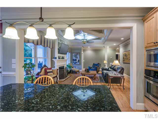 5120 Theys Road Raleigh, NC 27606 - Photo 23 of 25 The home offers a very open floor plan. The kitchen flows into the gorgeous, large family room with fireplace. The floor plan is perfect for entertaining & family time. Check out the detail on the ceiling & moldings! TV is on a pull-out swivel base. Den/Family/Great Room