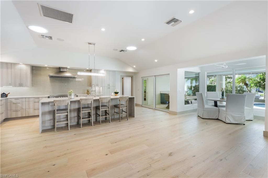 5215 Seashell Avenue Naples, FL 34103 - Photo 12 of 47 an open kitchen with a table and chairs