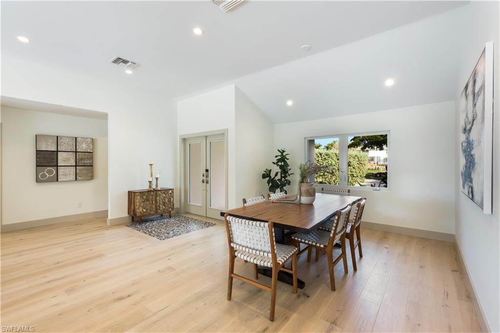 5215 Seashell Avenue Naples, FL 34103 - Photo 14 of 47 a view of a dining room with furniture and wooden floor