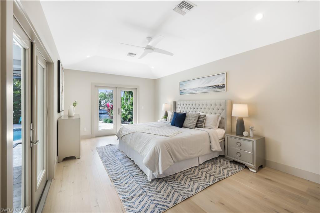 5215 Seashell Avenue Naples, FL 34103 - Photo 16 of 47 a bedroom with a large bed and a window