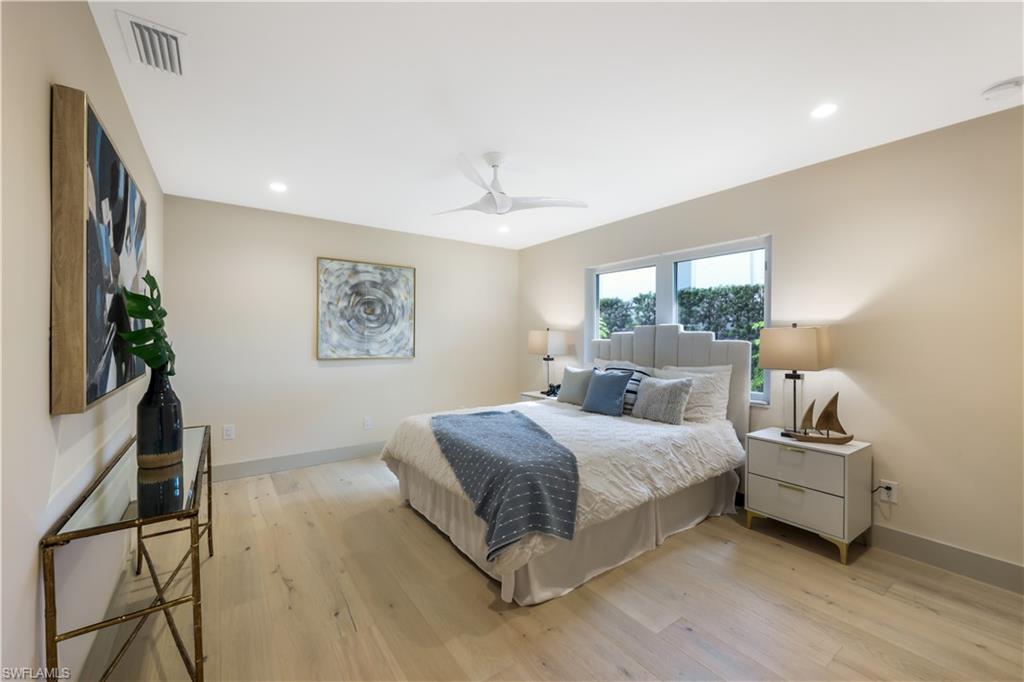 5215 Seashell Avenue Naples, FL 34103 - Photo 19 of 47 a bedroom with a bed and a flat screen tv