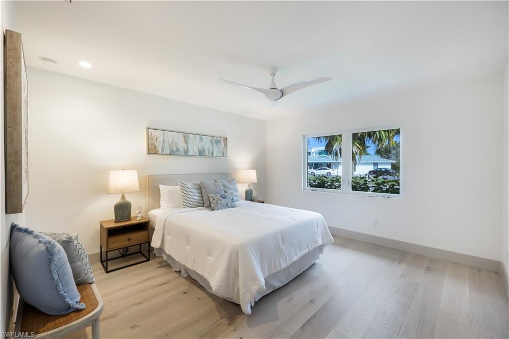 5215 Seashell Avenue Naples, FL 34103 - Photo 22 of 47 a bedroom with a bed and a painting on the wall