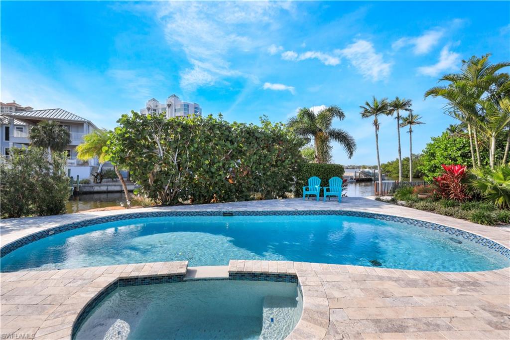 5215 Seashell Avenue Naples, FL 34103 - Photo 24 of 47 a view of a swimming pool with a yard