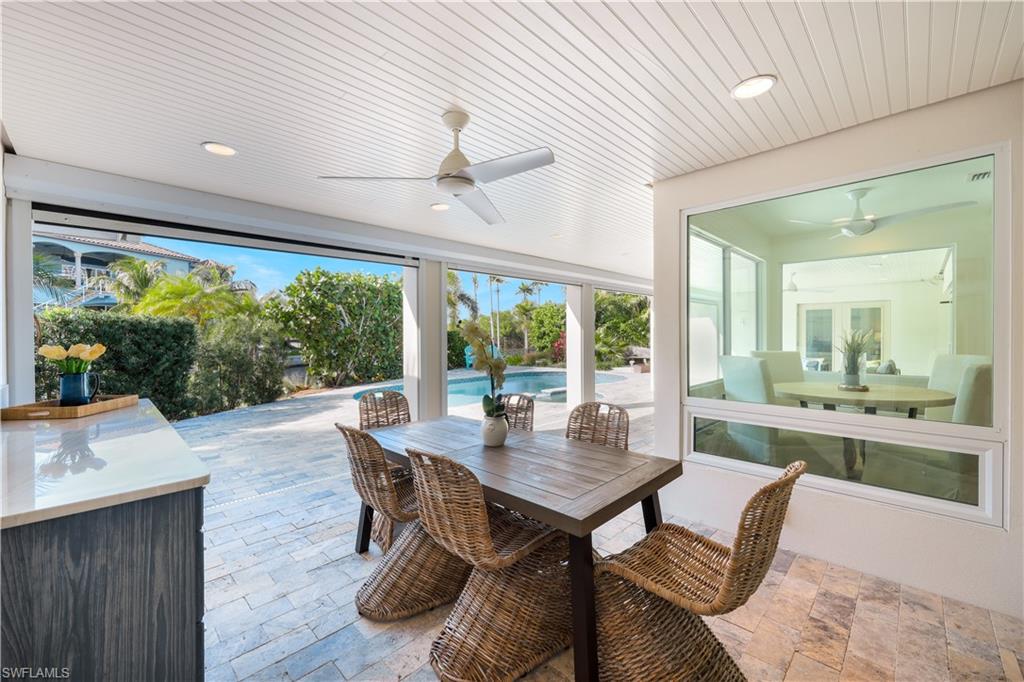 5215 Seashell Avenue Naples, FL 34103 - Photo 27 of 47 a dining room with furniture window and wooden floor