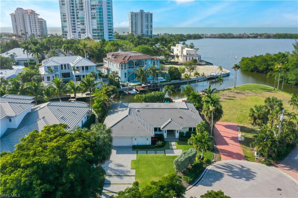 5215 Seashell Avenue Naples, FL 34103 - Photo 2 of 47 an aerial view of a house with a garden and lake view