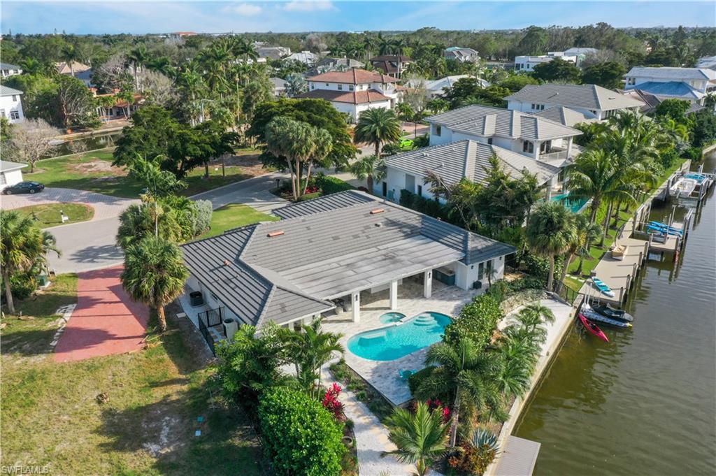 5215 Seashell Avenue Naples, FL 34103 - Photo 31 of 47 an aerial view of a house with a yard and lake view