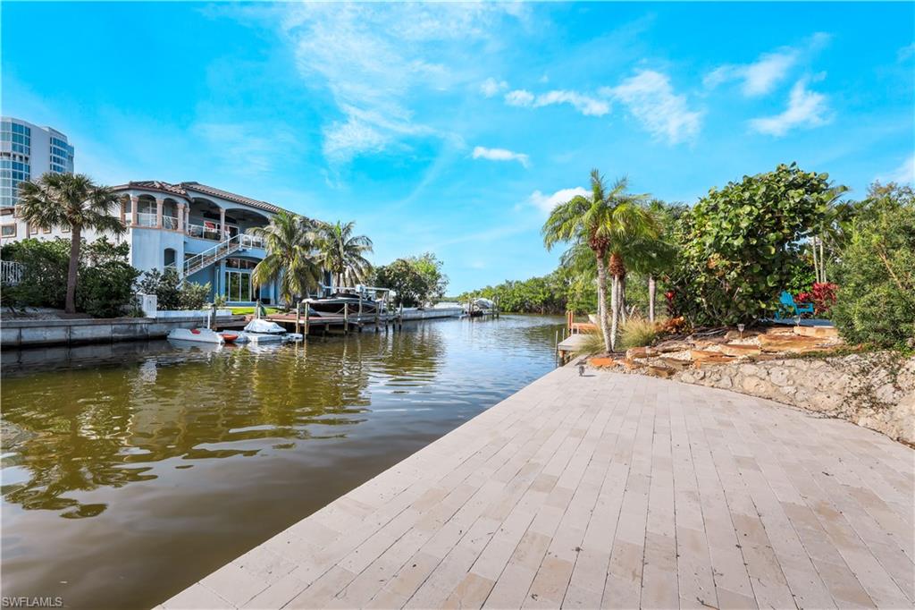 5215 Seashell Avenue Naples, FL 34103 - Photo 32 of 47 a view of a lake with a house in the background