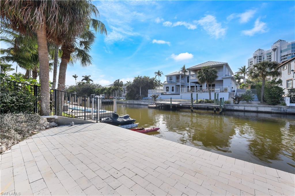 5215 Seashell Avenue Naples, FL 34103 - Photo 33 of 47 a view of a lake with a house