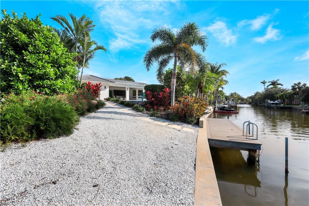 5215 Seashell Avenue Naples, FL 34103 - Photo 34 of 47 a view of a lake with houses
