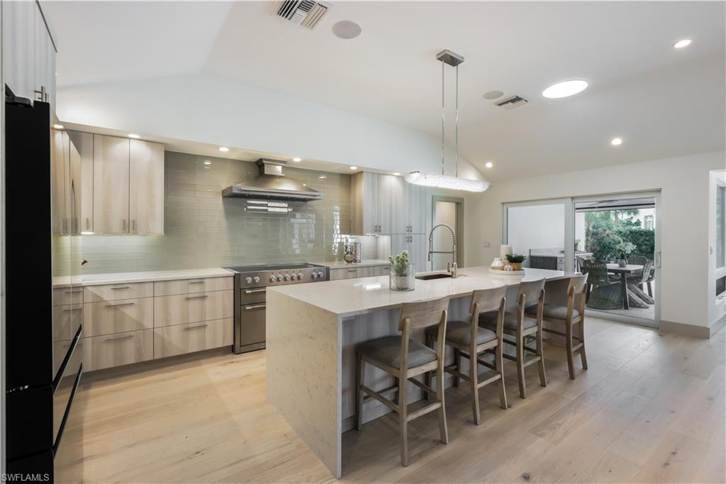 5215 Seashell Avenue Naples, FL 34103 - Photo 5 of 47 a large kitchen with a table and chairs in it