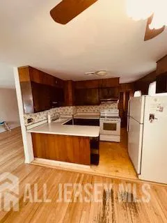 a view of kitchen with stainless steel appliances cabinets and wooden floor