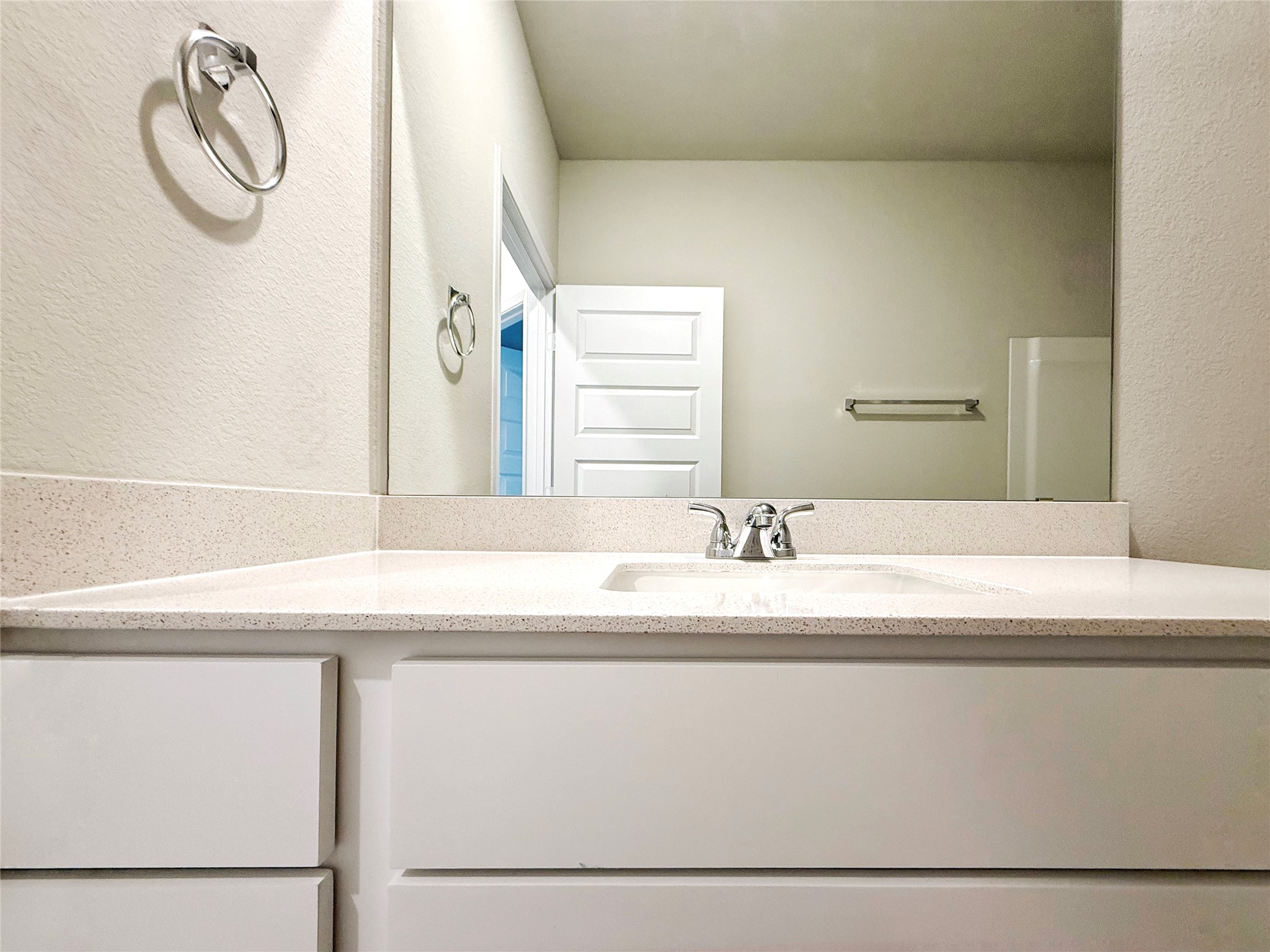 2714 Towy Road Manor, TX 78653 - Photo 11 of 22 A well-appointed bathroom vanity features a pristine counter and a large mirror.