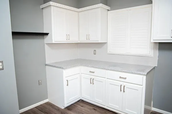 a kitchen with white cabinets and white appliances