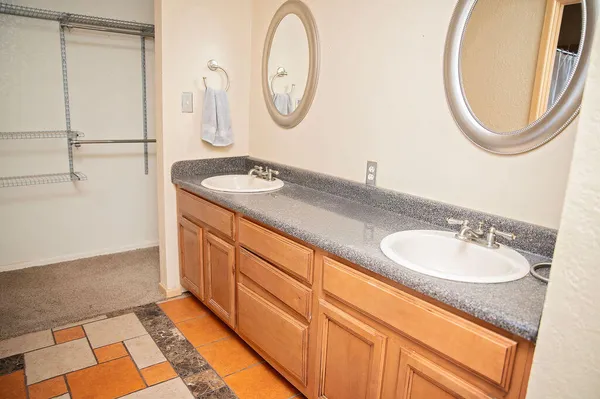 a bathroom with a granite countertop sink and a mirror