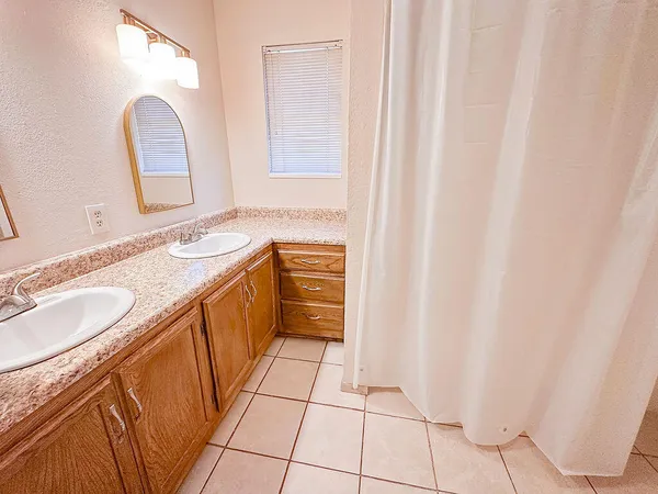 a bathroom with a double vanity sink and mirror