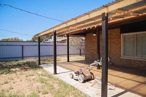 a view of a patio with a table and chairs