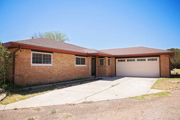 a front view of a house with a big yard