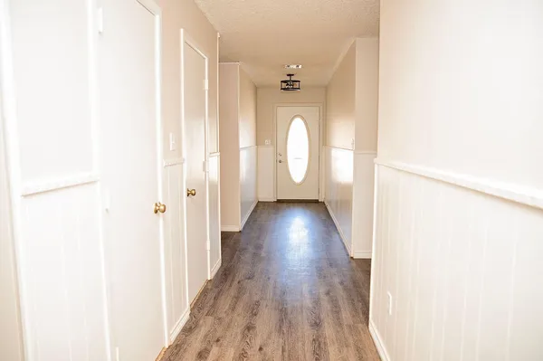 a view of a hallway with wooden floor