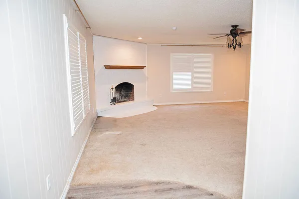a view of a room with a fireplace and a window