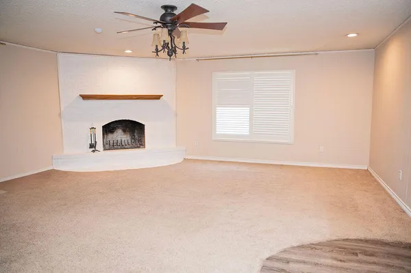 a view of empty room with fan and window
