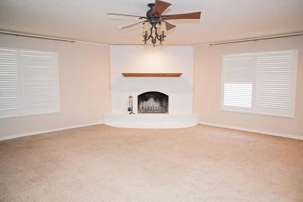 a view of a fireplace and window in the room