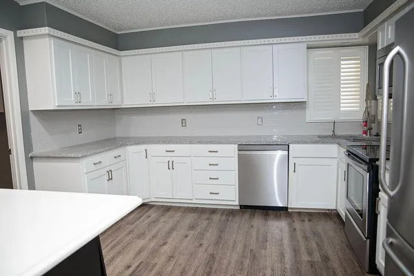 a kitchen with appliances cabinets and a sink
