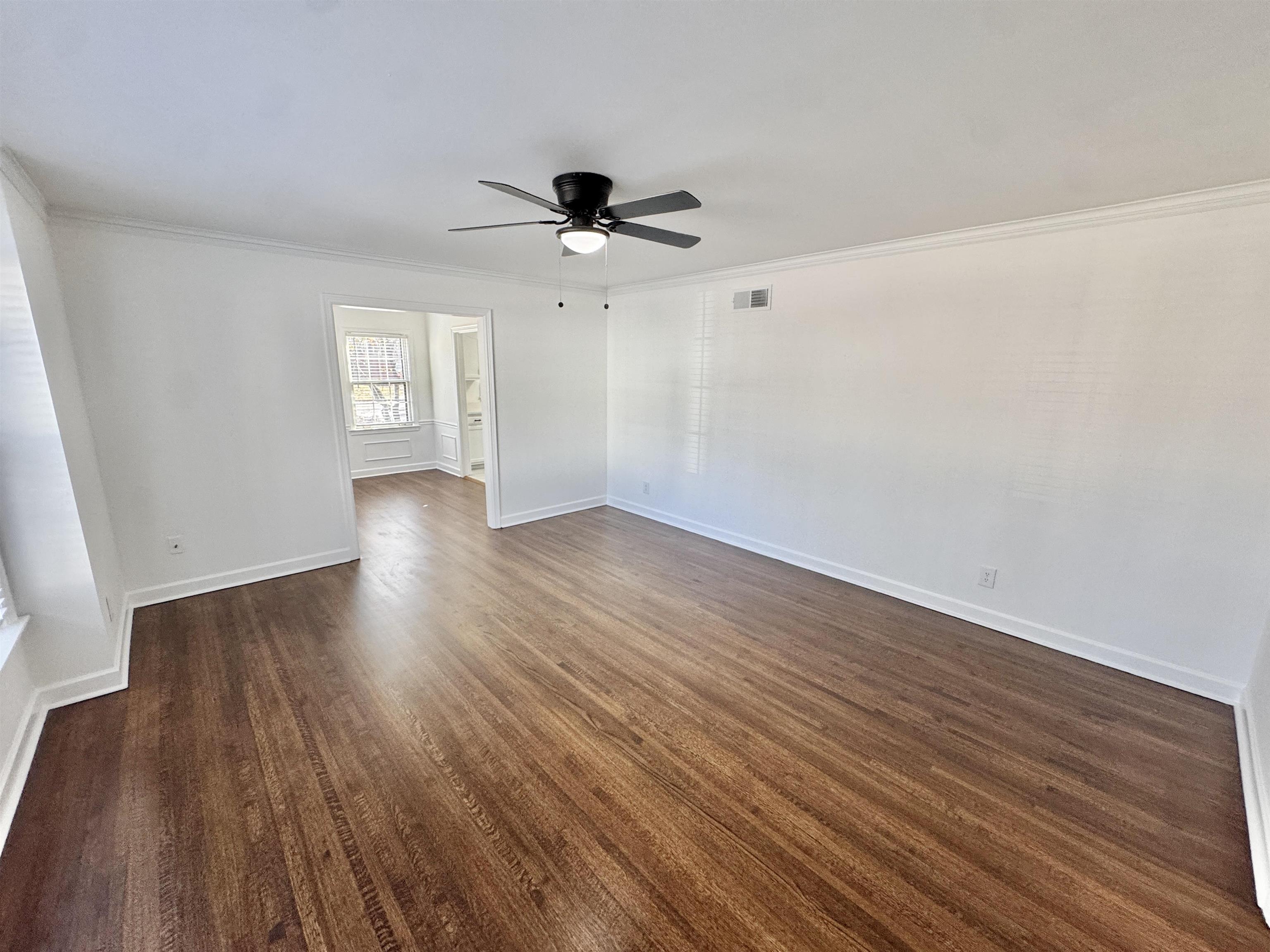 4417 Fair Meadow Road Memphis, TN 38117 - Photo 19 of 38 Unfurnished room featuring a ceiling fan, ornamental molding, and dark wood-type flooring
