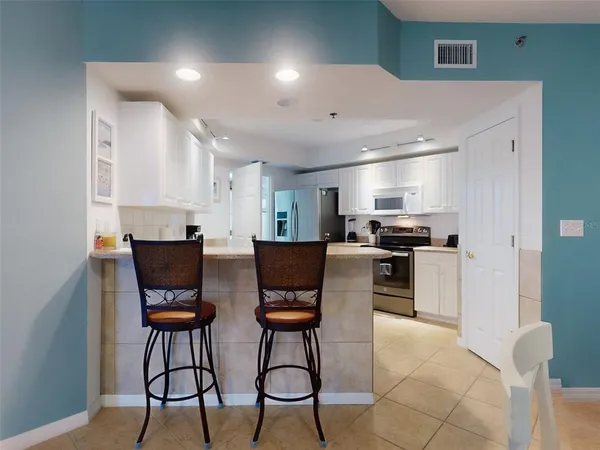 a kitchen with white cabinets sink and white appliances