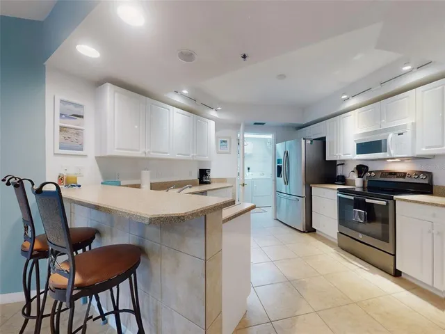 a kitchen with a refrigerator and cabinets