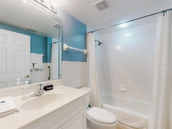 a bedroom with a bed and a night stand